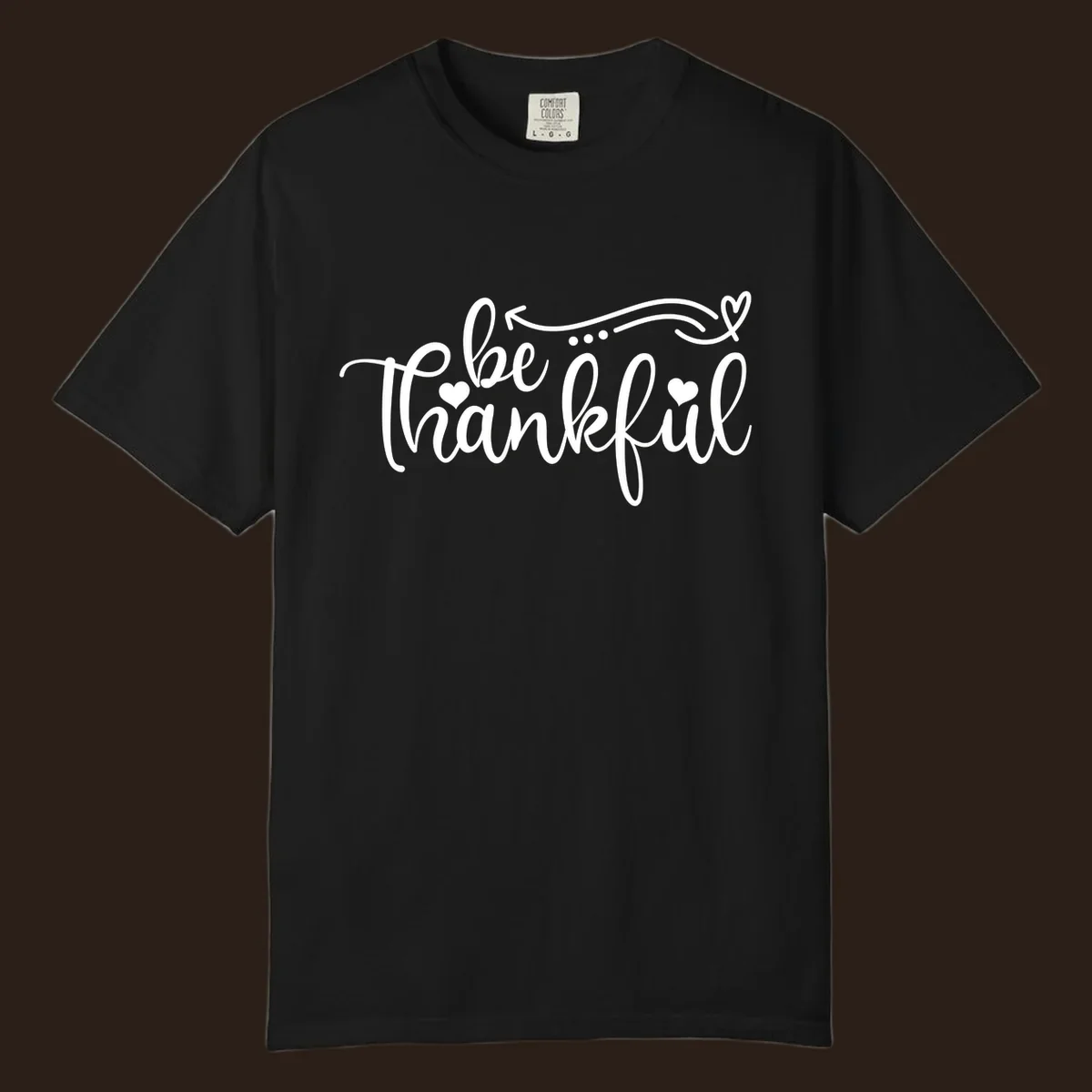 White script text 'be thankful' with hearts and decorative swirls for Thanksgiving.