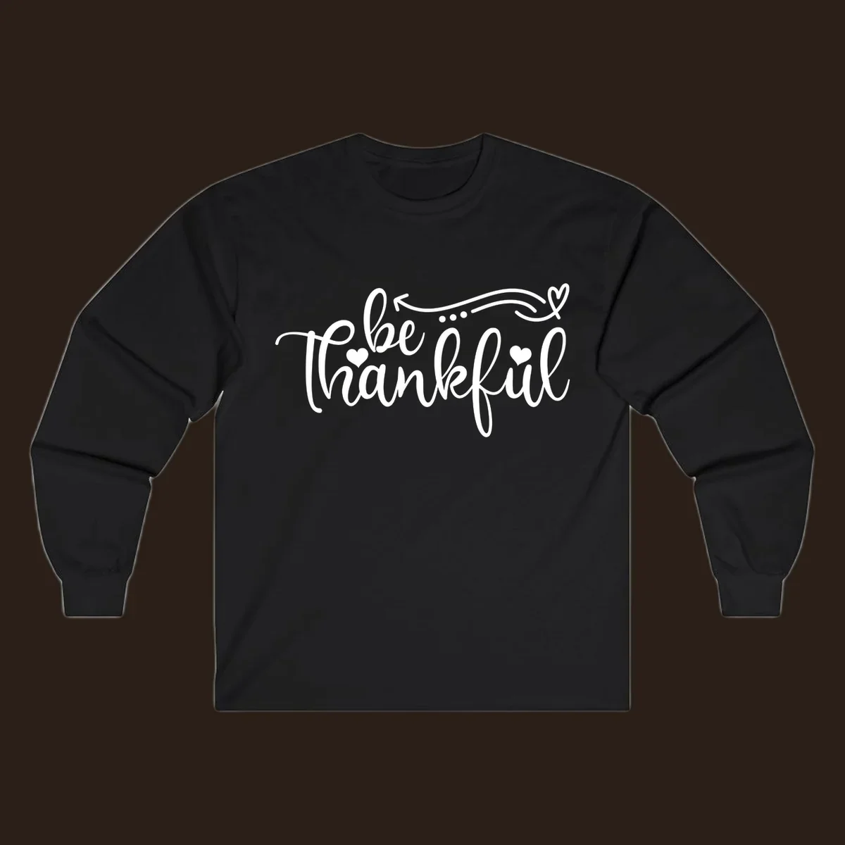 White script text 'be thankful' with hearts and decorative swirls for Thanksgiving.