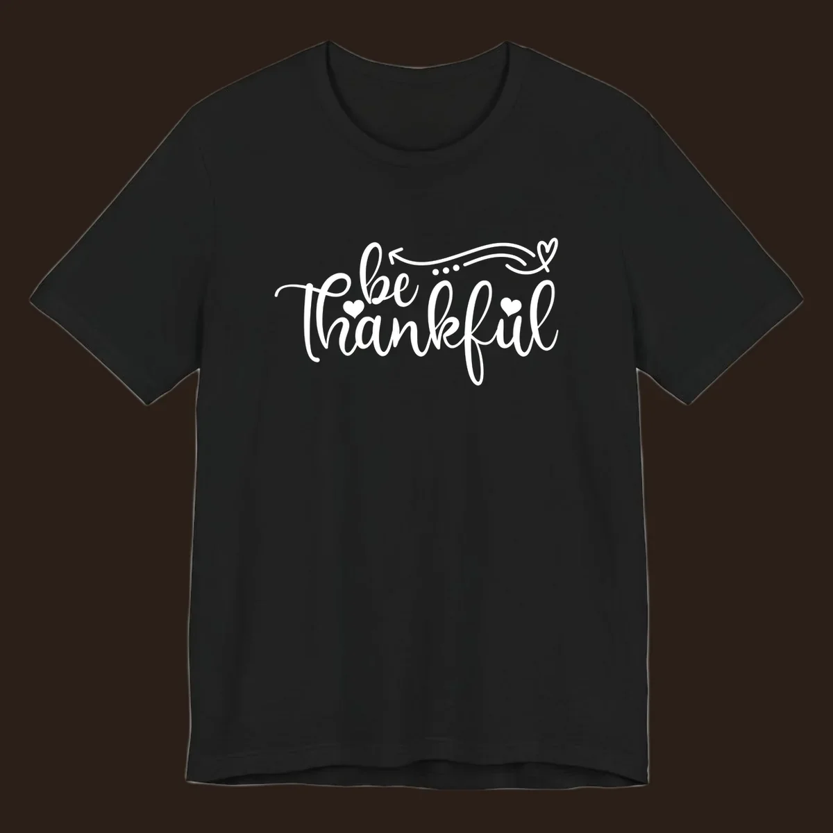 White script text 'be thankful' with hearts and decorative swirls for Thanksgiving.