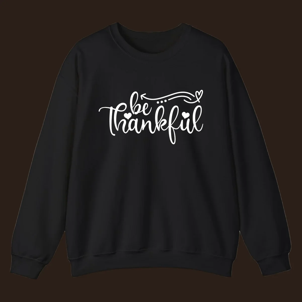 White script text 'be thankful' with hearts and decorative swirls for Thanksgiving.