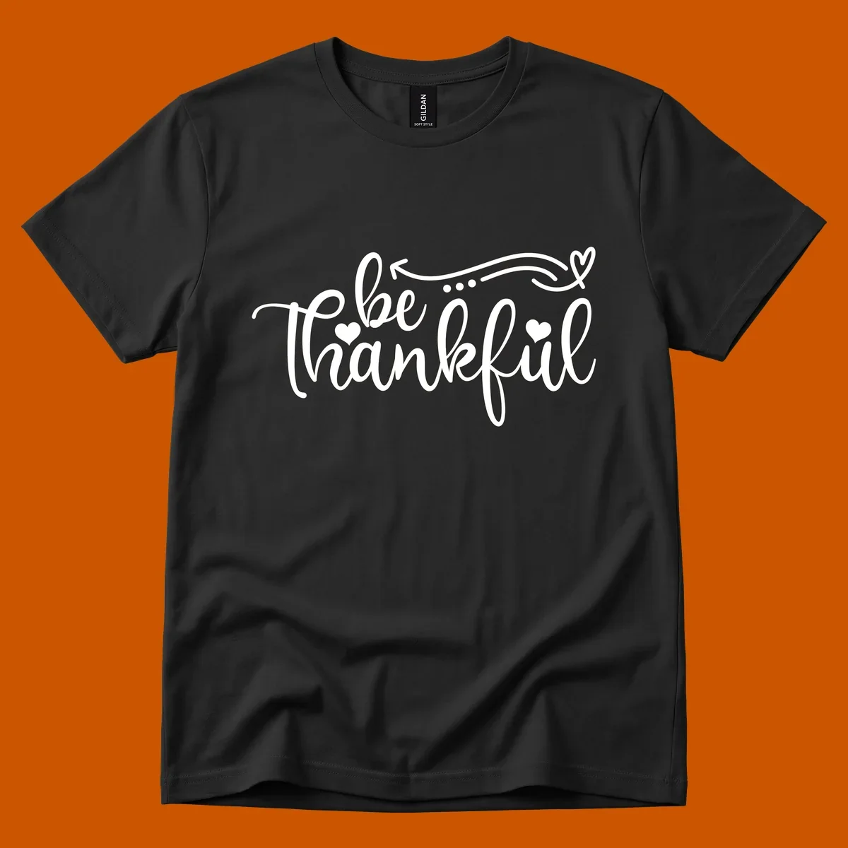 White script text 'be thankful' with hearts and decorative swirls for Thanksgiving.