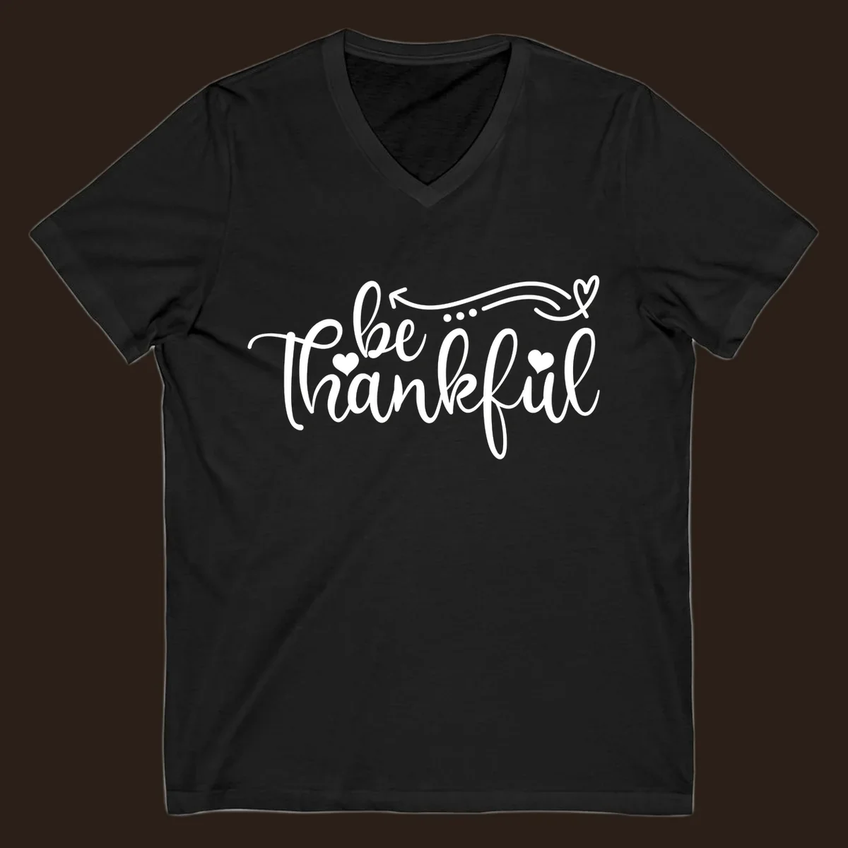White script text 'be thankful' with hearts and decorative swirls for Thanksgiving.
