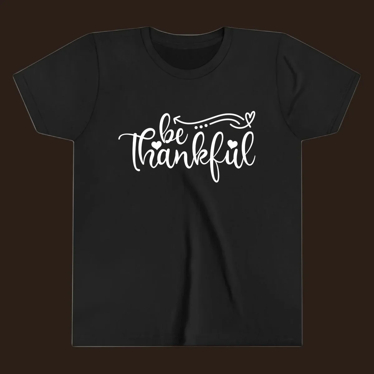 White script text 'be thankful' with hearts and decorative swirls for Thanksgiving.