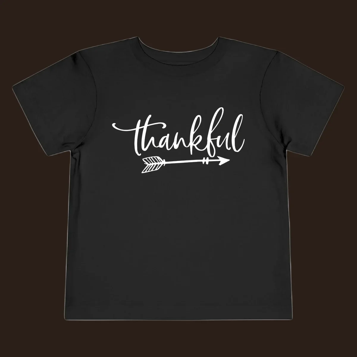 Thankful text with an arrow graphic, Thanksgiving theme.