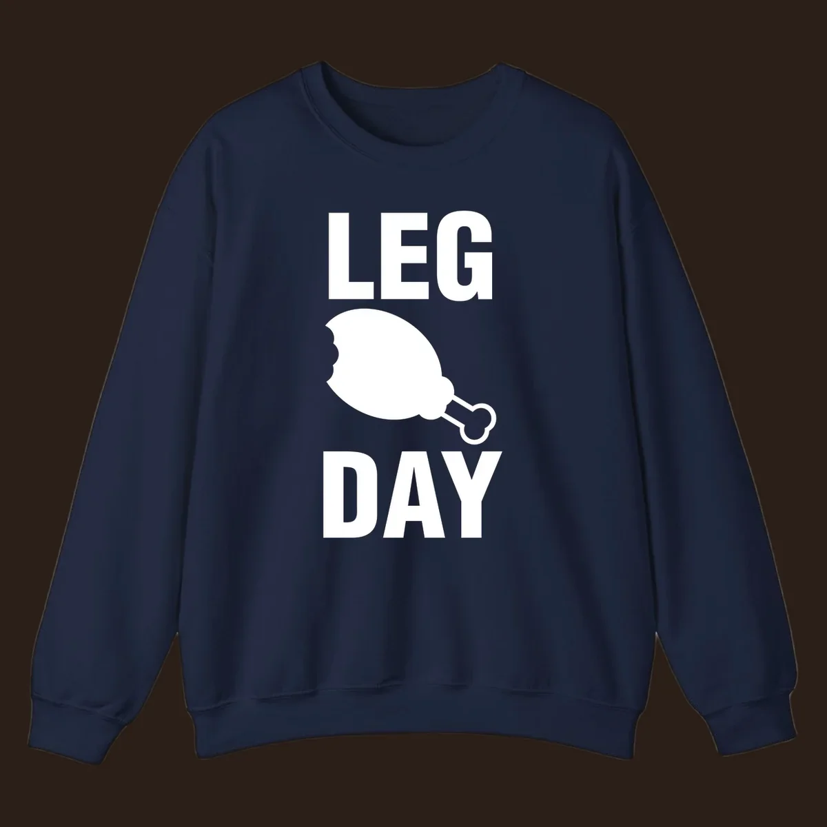 Leg Day text with a bitten chicken leg graphic. Humor fitness design.