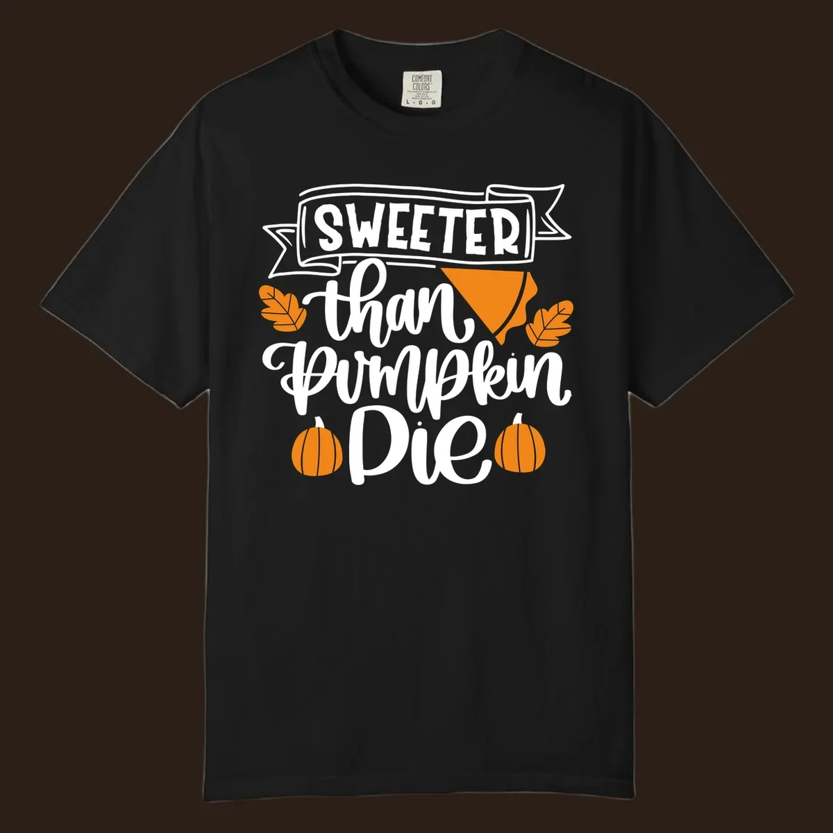 Sweeter than pumpkin pie thanksgiving design with text, pie slice, leaves, and pumpkins.
