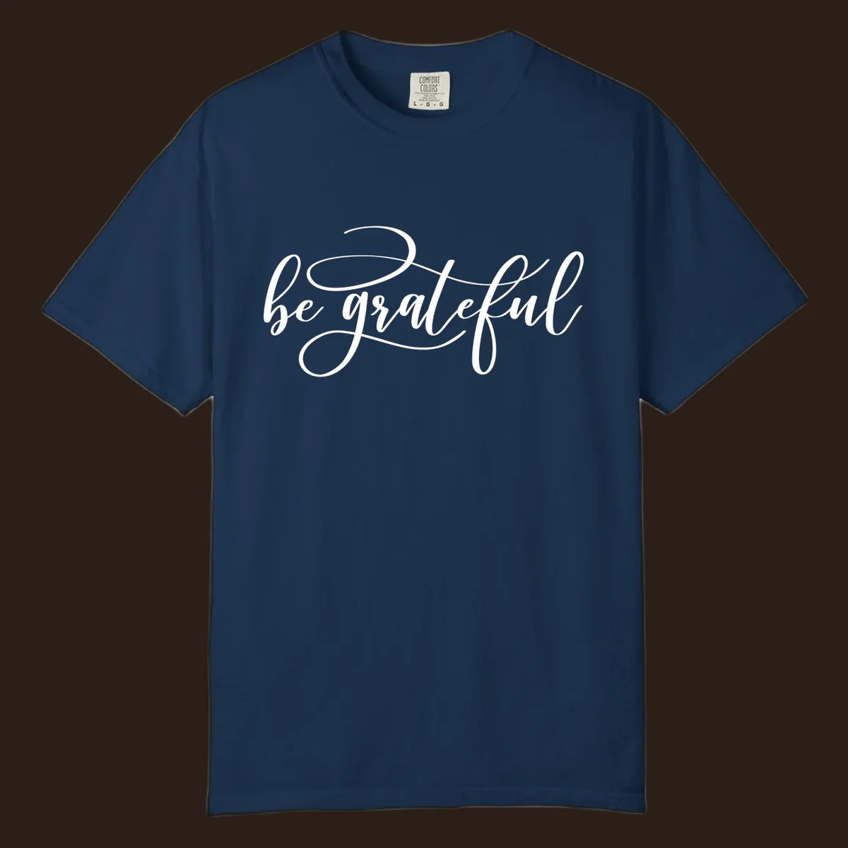 White script text that says 'be grateful' on a black background.