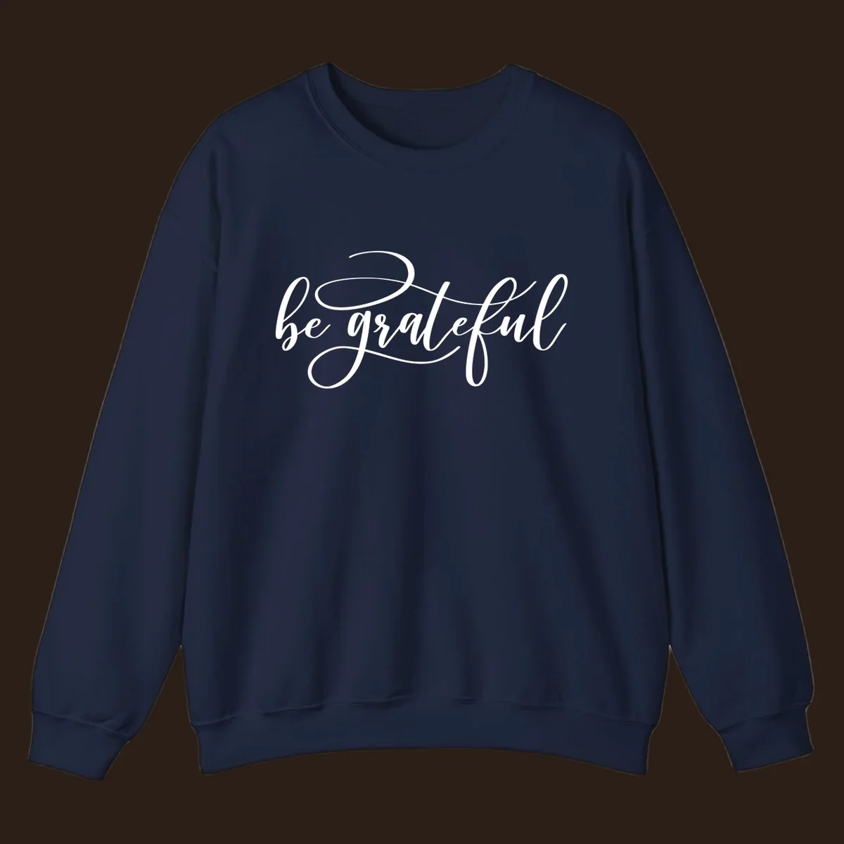 White script text that says 'be grateful' on a black background.