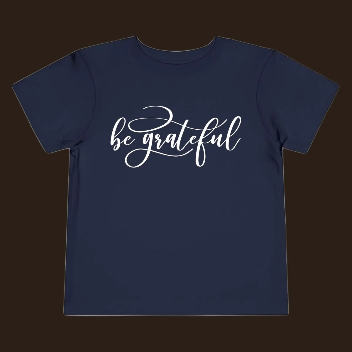 White script text that says 'be grateful' on a black background.