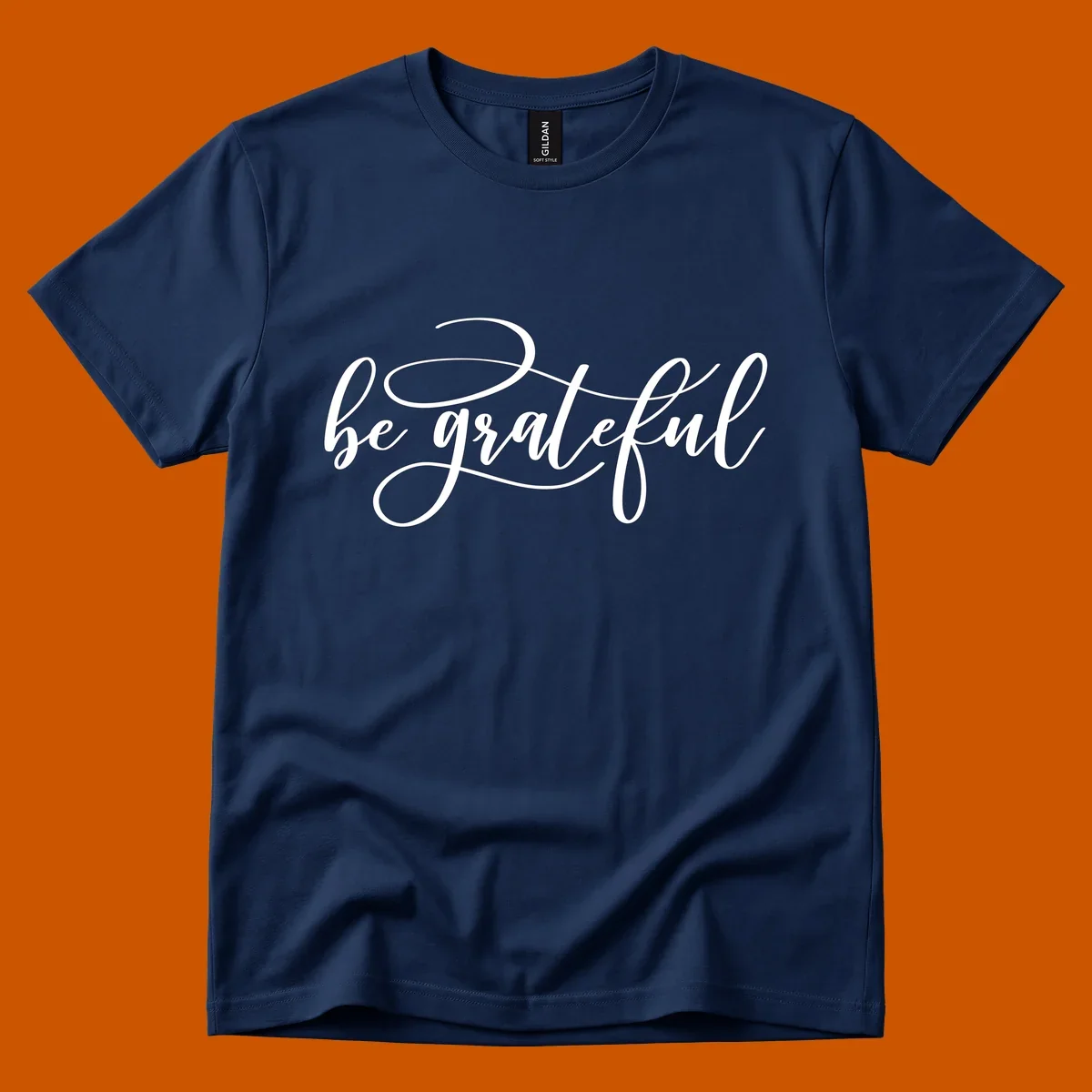 White script text that says 'be grateful' on a black background.