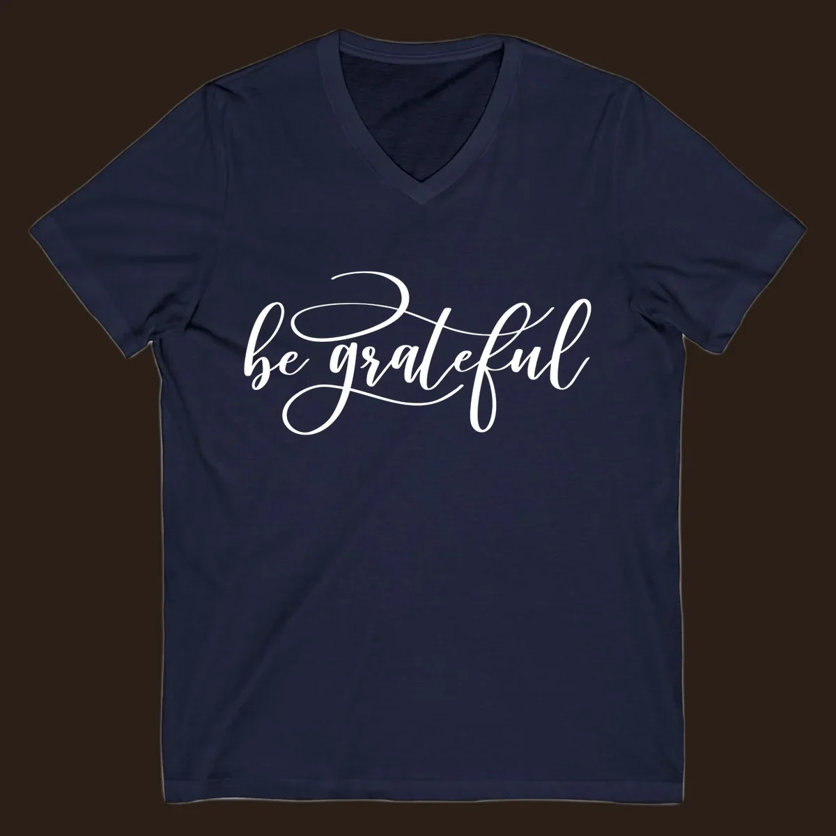White script text that says 'be grateful' on a black background.