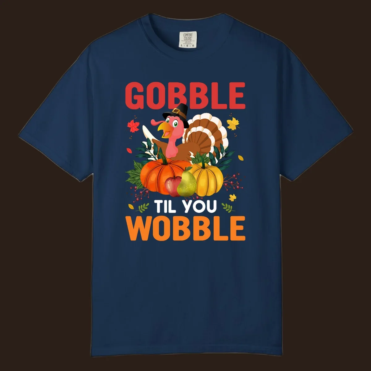 Gobble Til You Wobble Thanksgiving turkey illustration with pumpkins and text.