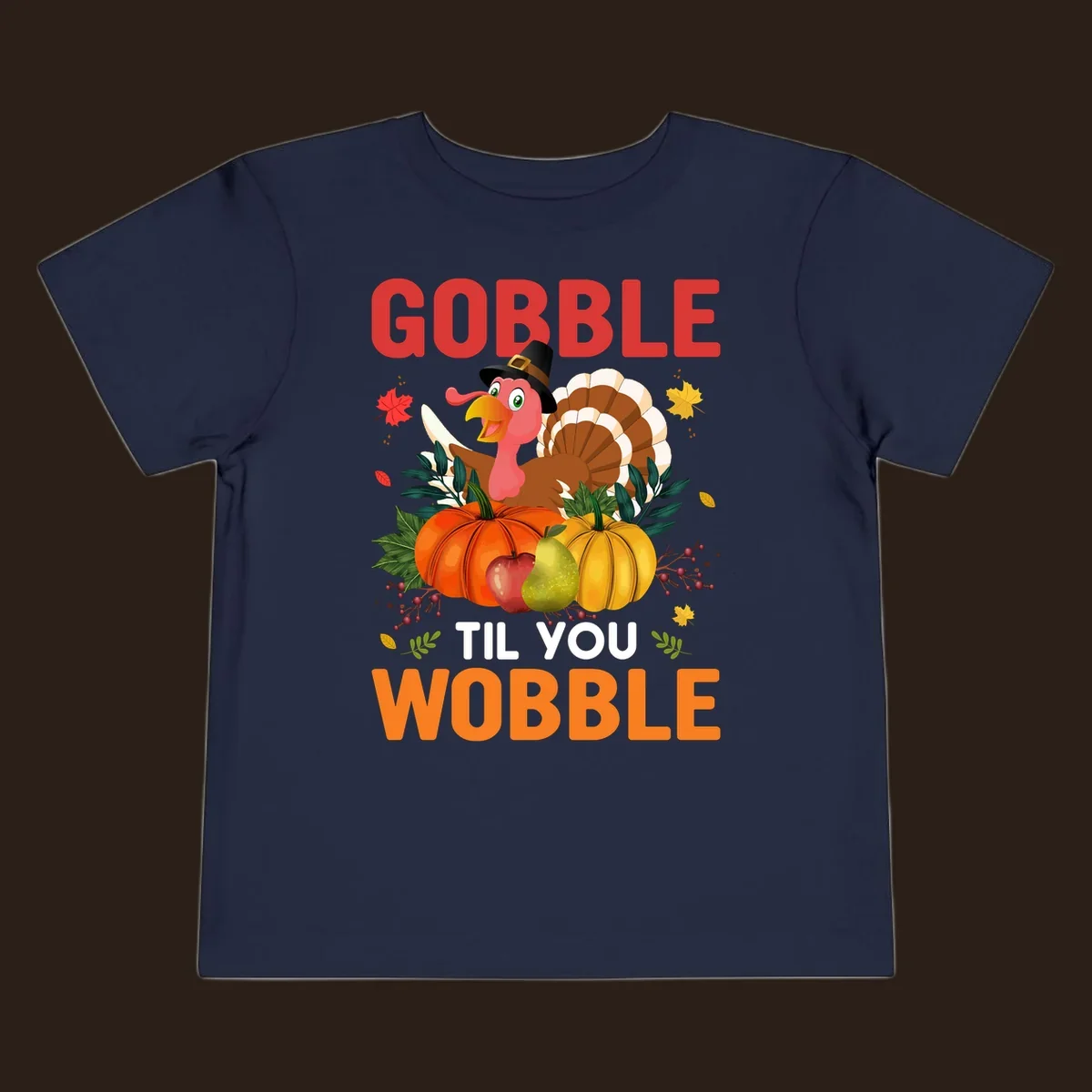 Gobble Til You Wobble Thanksgiving turkey illustration with pumpkins and text.