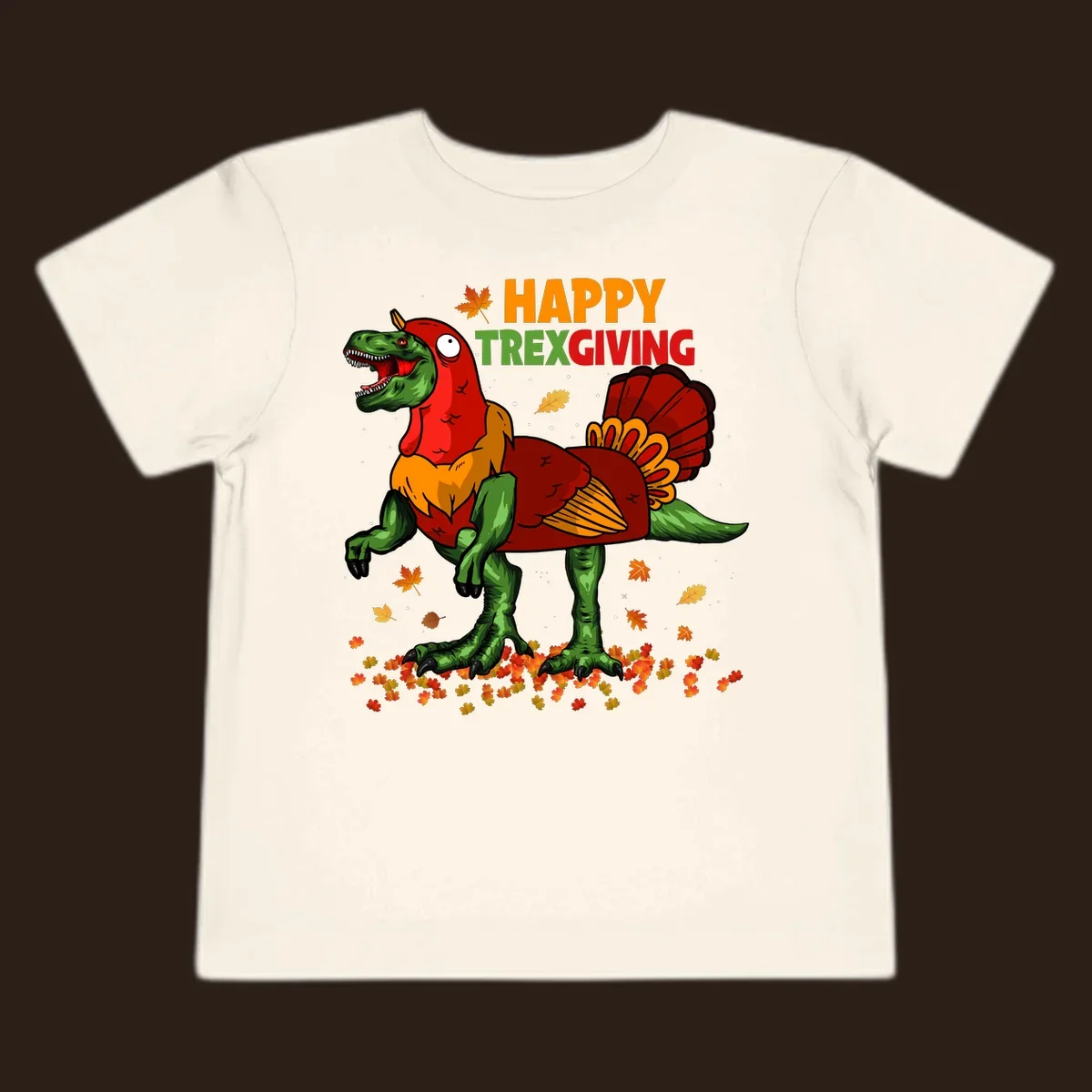 Dinosaur in a turkey costume with 'Happy Trexgiving' text and fall leaves.