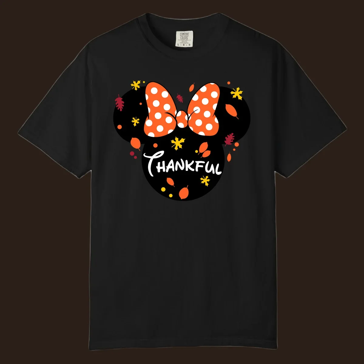 Minnie Mouse silhouette with polka dot bow and 'THANKFUL' text, surrounded by fall leaves.