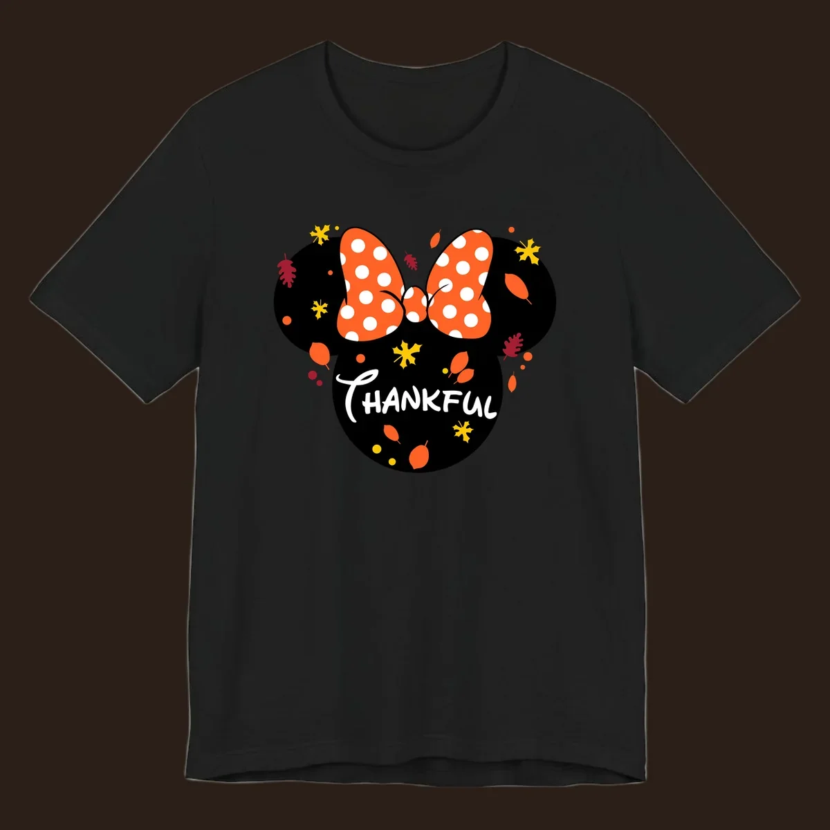 Minnie Mouse silhouette with polka dot bow and 'THANKFUL' text, surrounded by fall leaves.