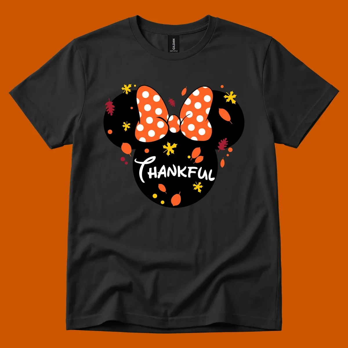 Minnie Mouse silhouette with polka dot bow and 'THANKFUL' text, surrounded by fall leaves.