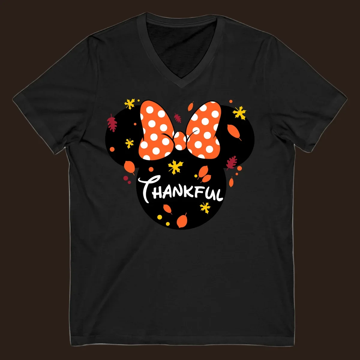 Minnie Mouse silhouette with polka dot bow and 'THANKFUL' text, surrounded by fall leaves.