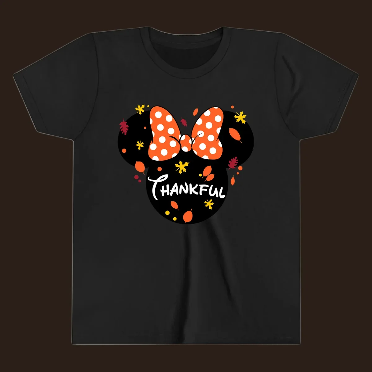 Minnie Mouse silhouette with polka dot bow and 'THANKFUL' text, surrounded by fall leaves.
