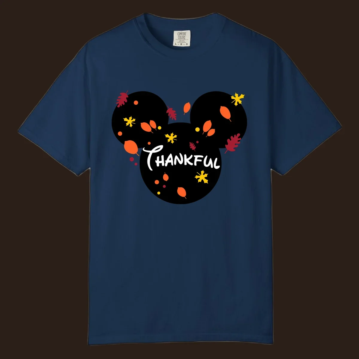 Mickey ears shape with fall leaves and the word THANKFUL in white text.