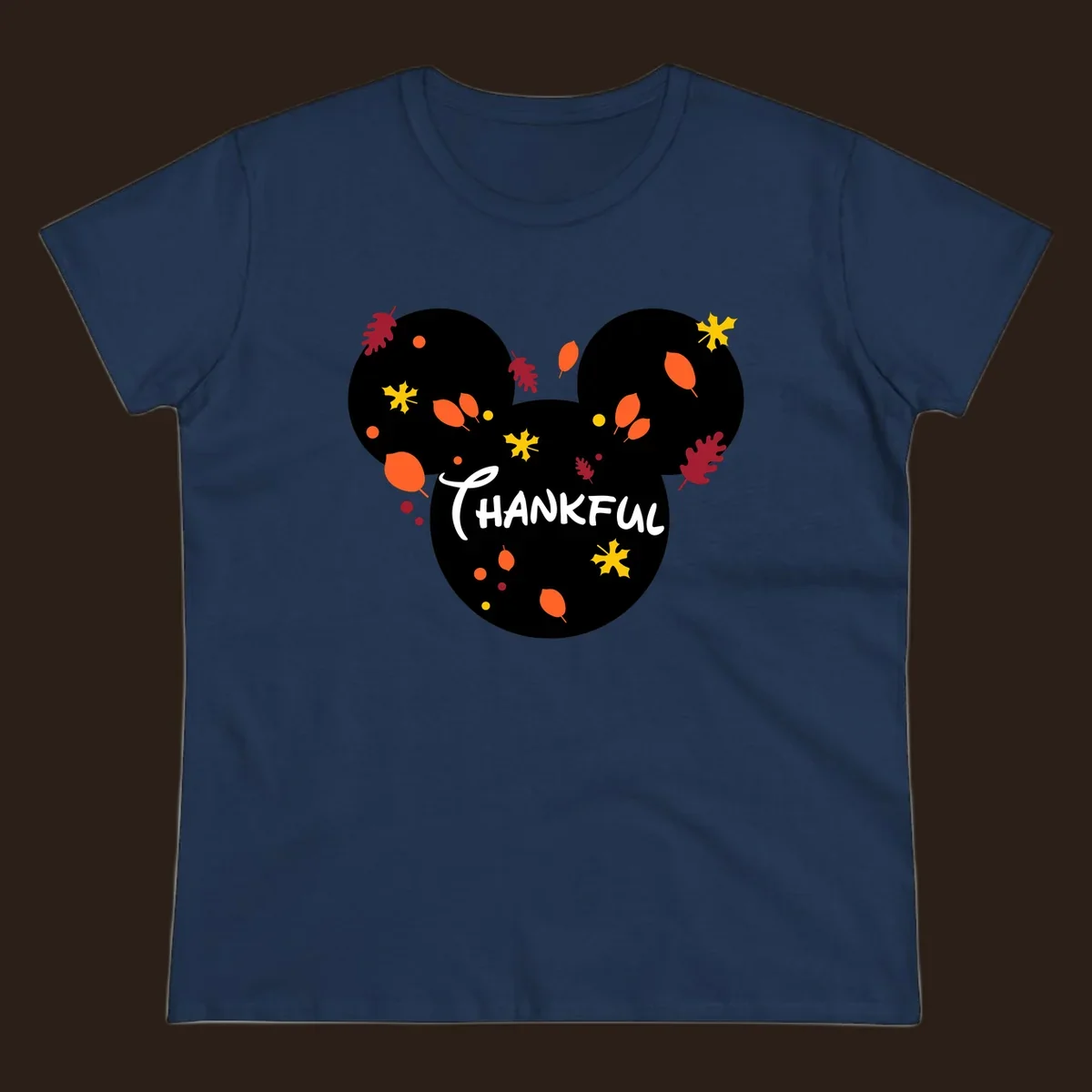 Mickey ears shape with fall leaves and the word THANKFUL in white text.
