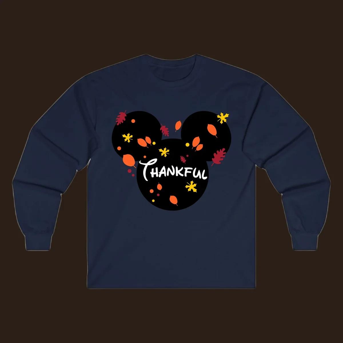 Mickey ears shape with fall leaves and the word THANKFUL in white text.