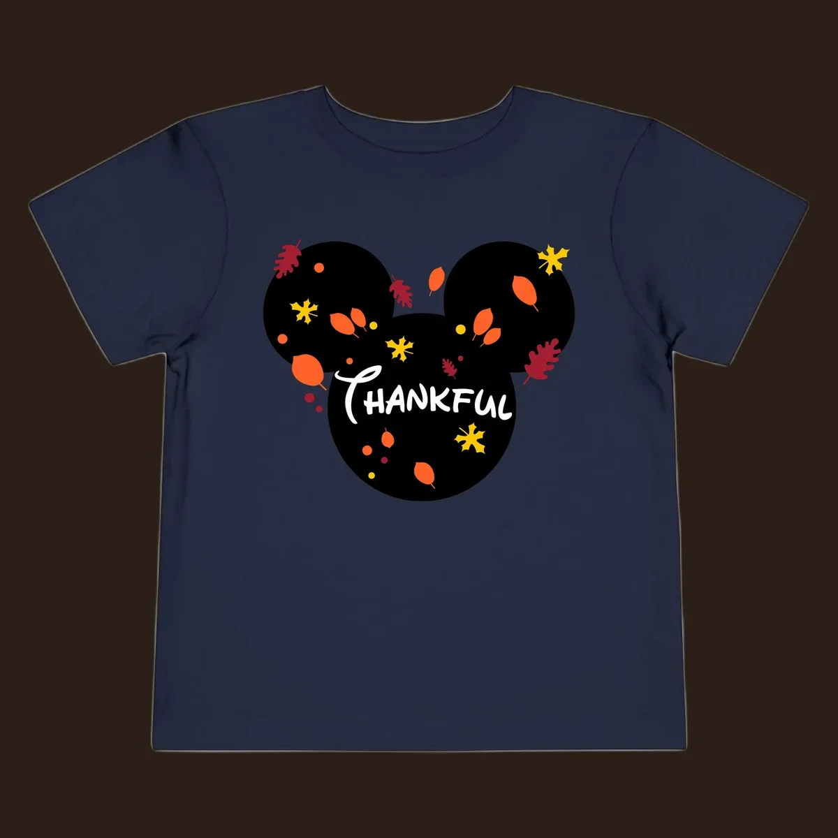 Mickey ears shape with fall leaves and the word THANKFUL in white text.