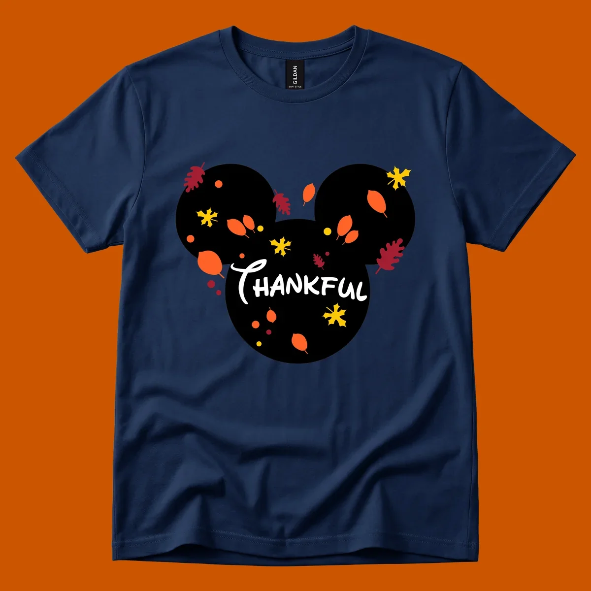 Mickey ears shape with fall leaves and the word THANKFUL in white text.