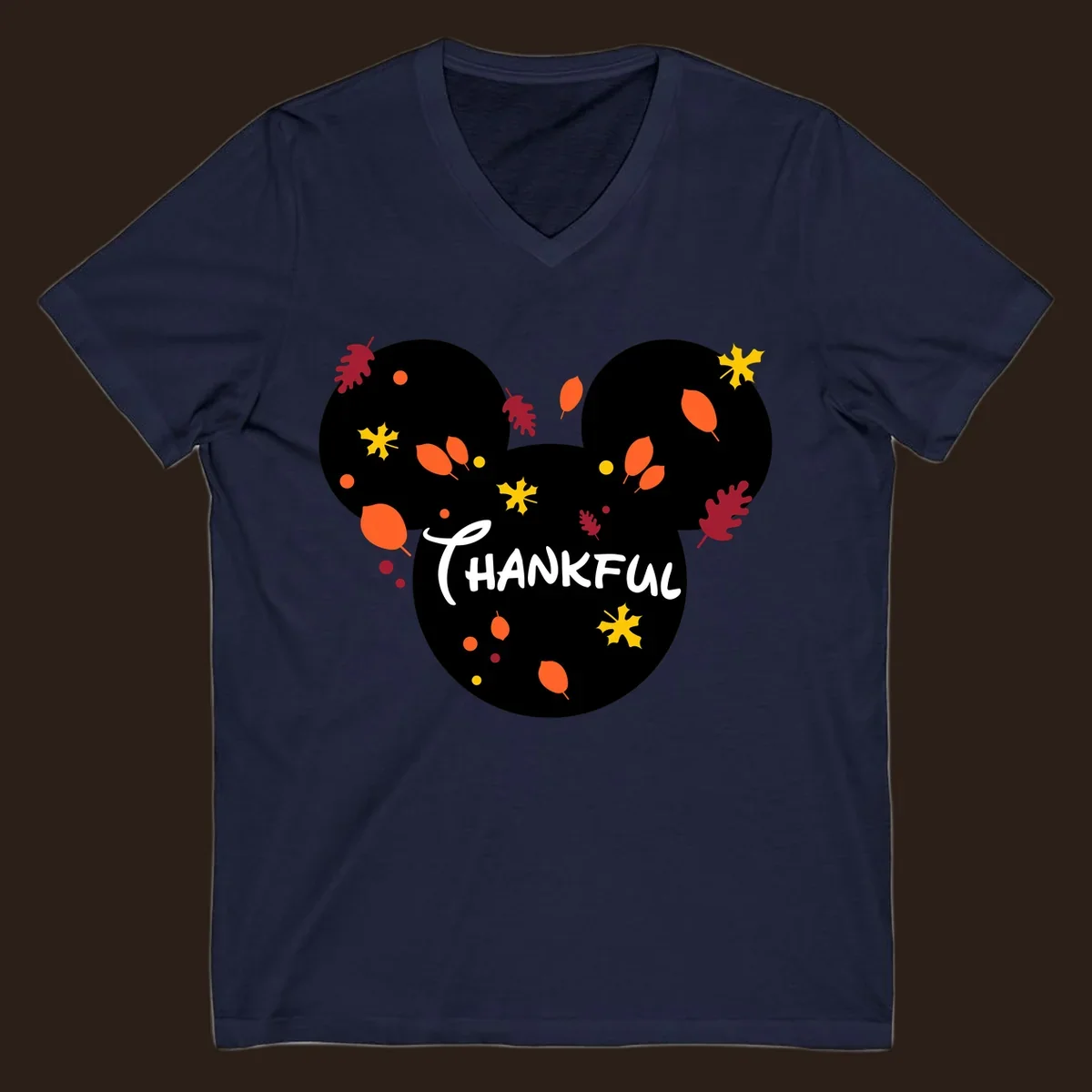 Mickey ears shape with fall leaves and the word THANKFUL in white text.