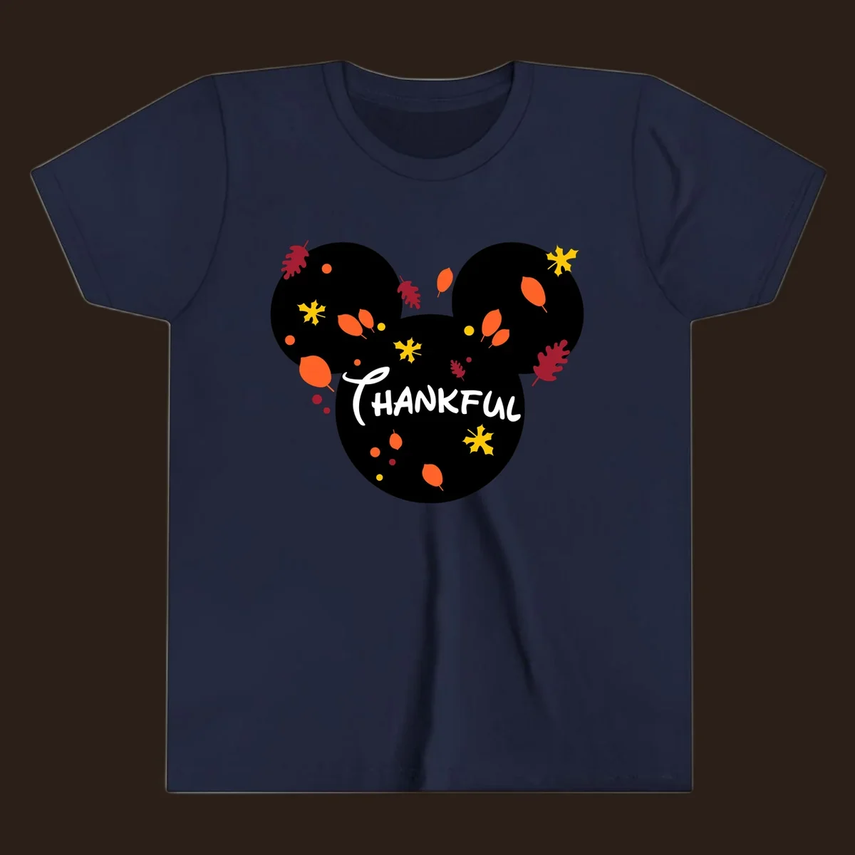 Mickey ears shape with fall leaves and the word THANKFUL in white text.