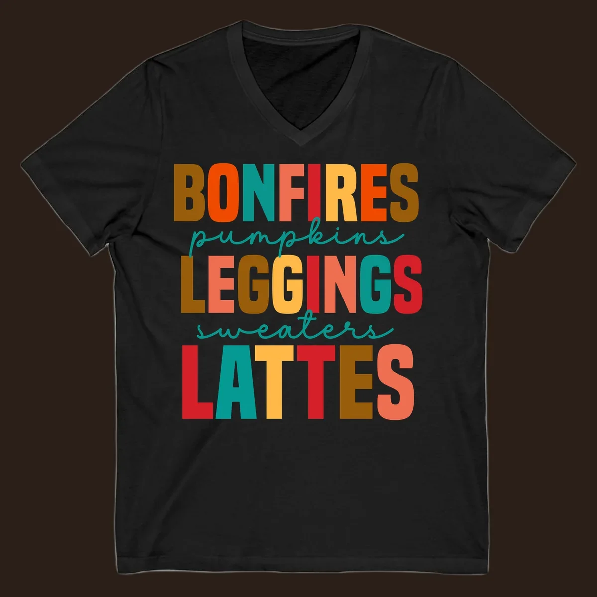 Fall vibes text design with words like Bonfires, Pumpkins, Leggings, Sweaters, Lattes in colorful block letters.