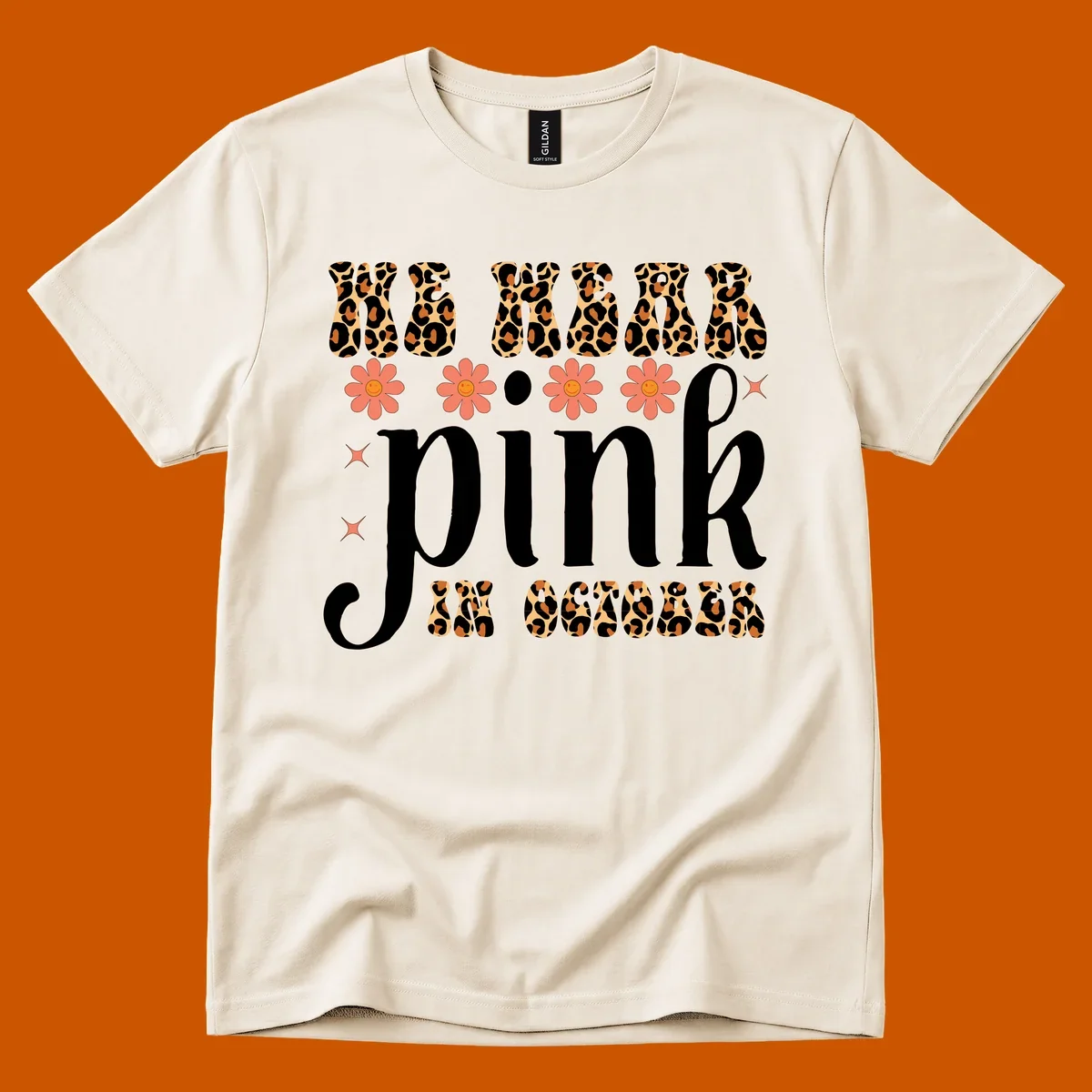 Retro "WE WEAR pink IN OCTOBER" design with leopard print and smiling flowers.