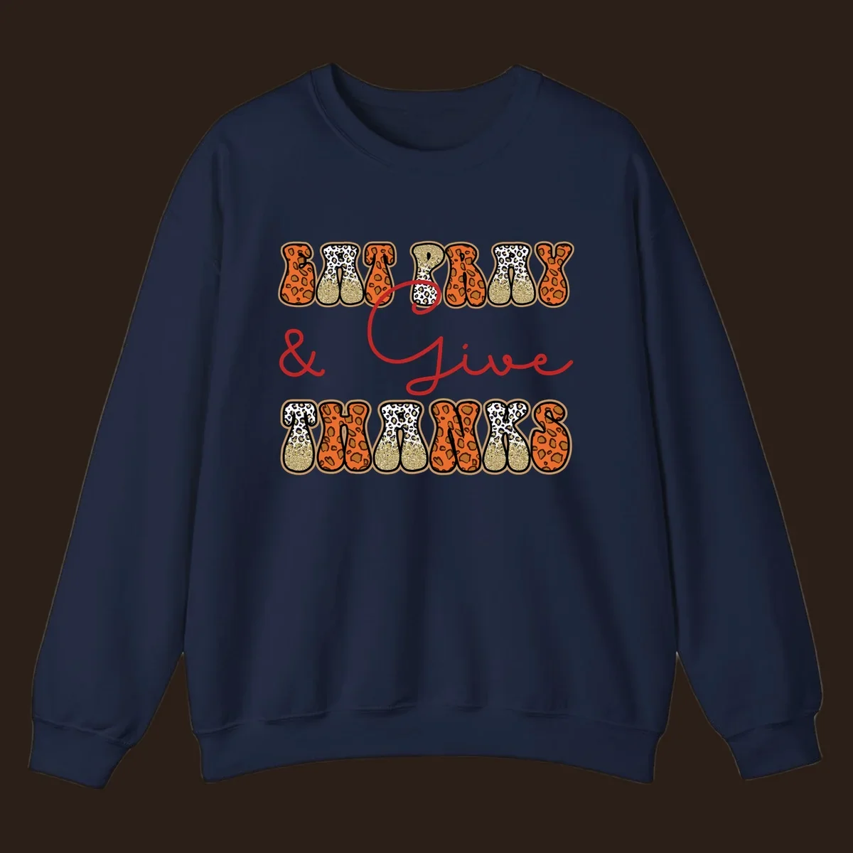 Eat Pray Give Thanks leopard print text design with gold glitter accents.