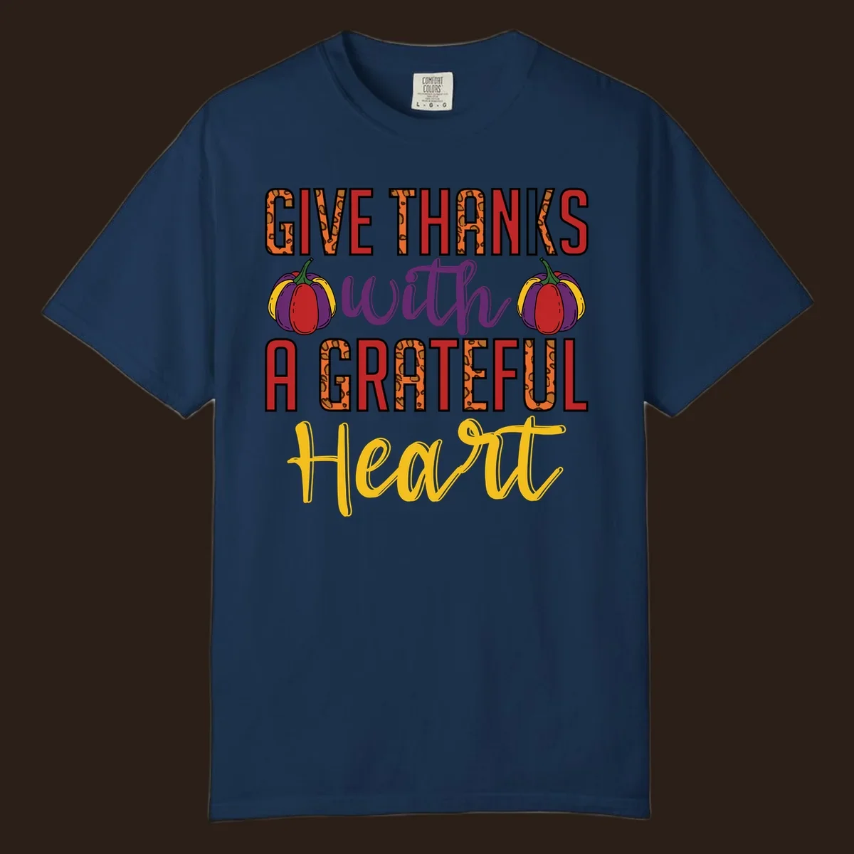 Give Thanks With A Heart typography and pumpkin design.