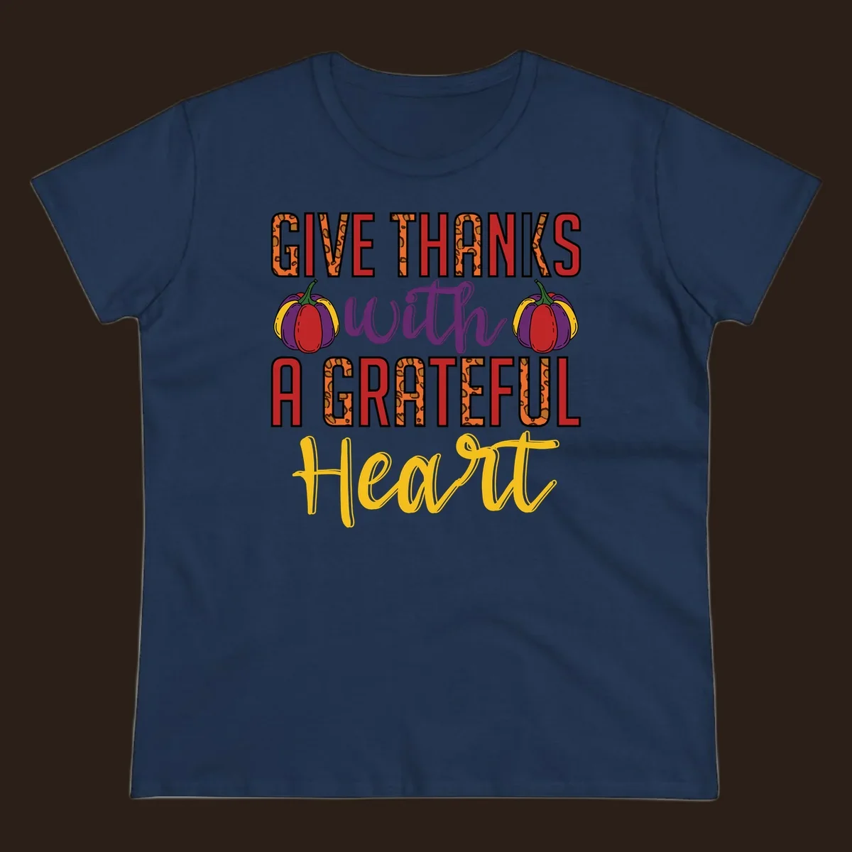 Give Thanks With A Heart typography and pumpkin design.