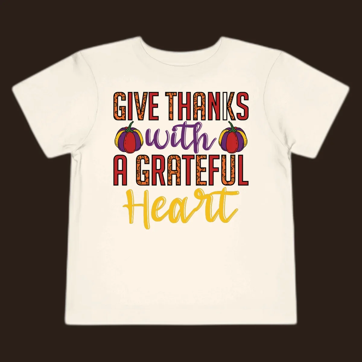 Give Thanks With A Heart typography and pumpkin design.