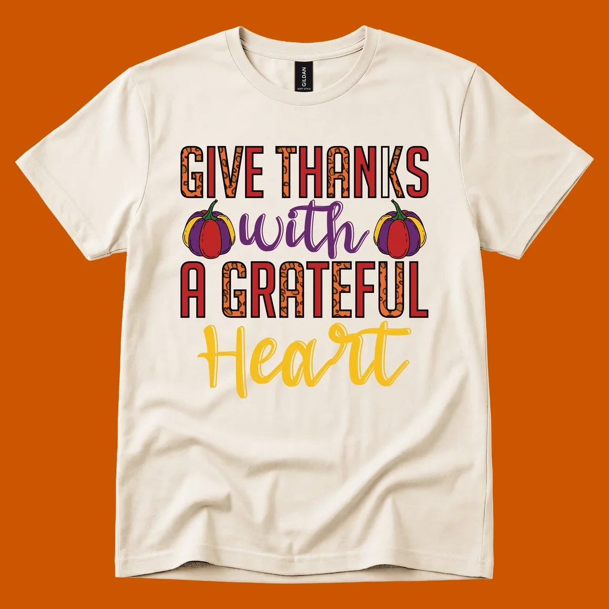 Give Thanks With A Heart typography and pumpkin design.