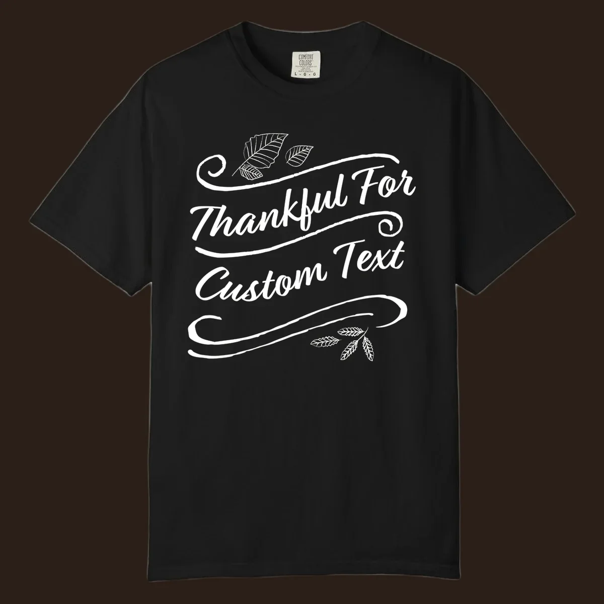 Custom Thanksgiving text design with leaves and swirls.
