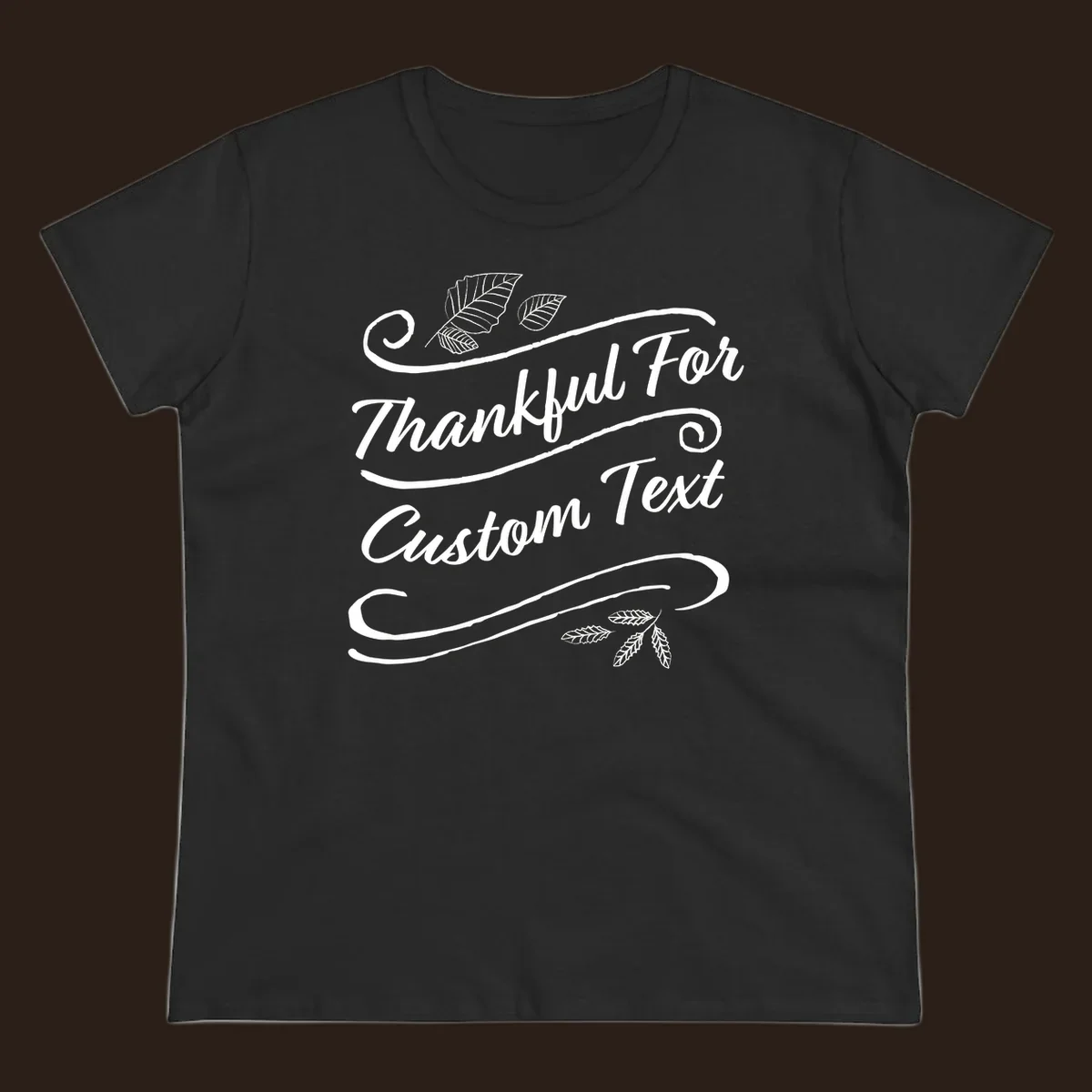 Custom Thanksgiving text design with leaves and swirls.