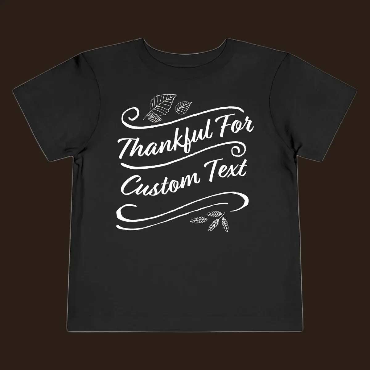 Custom Thanksgiving text design with leaves and swirls.