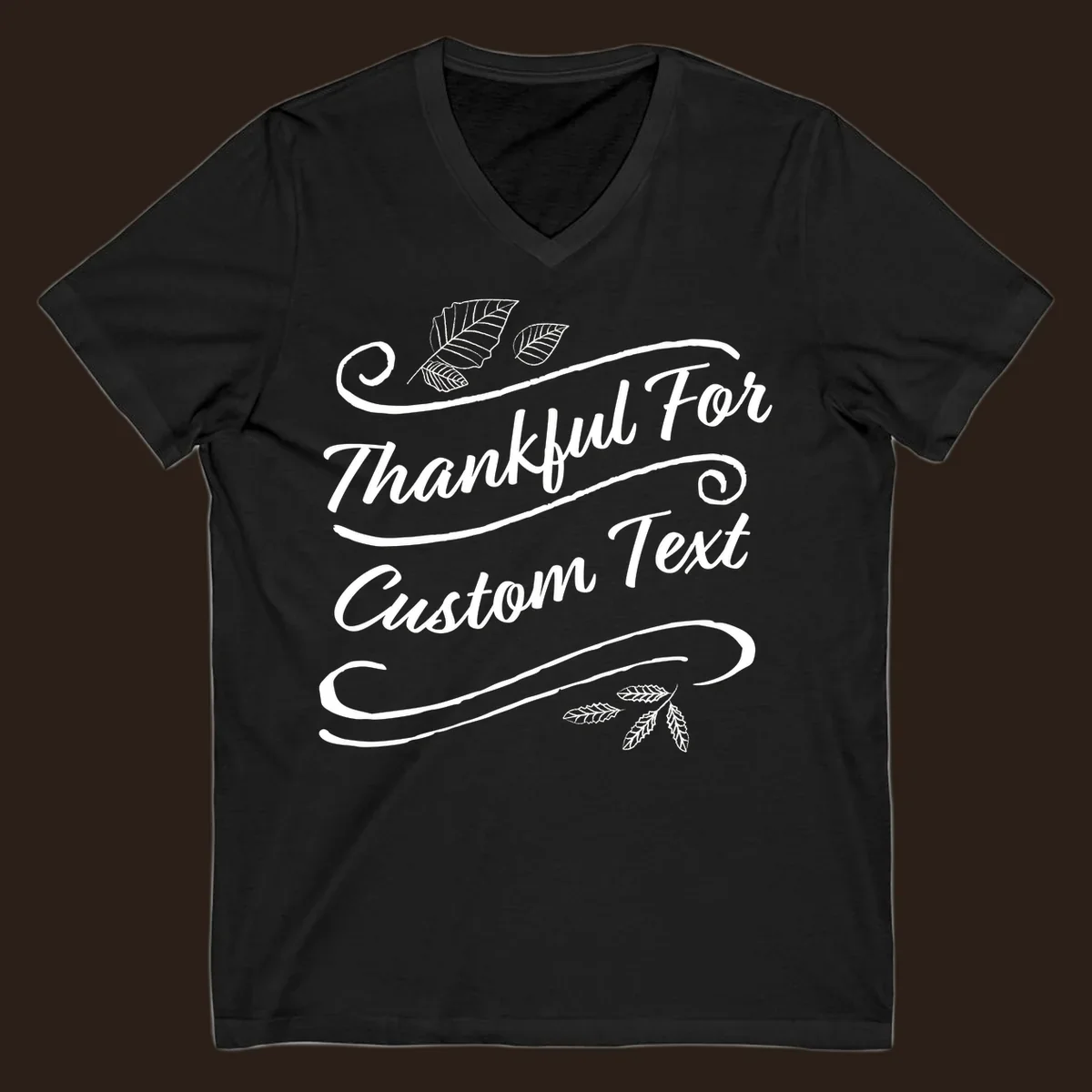 Custom Thanksgiving text design with leaves and swirls.