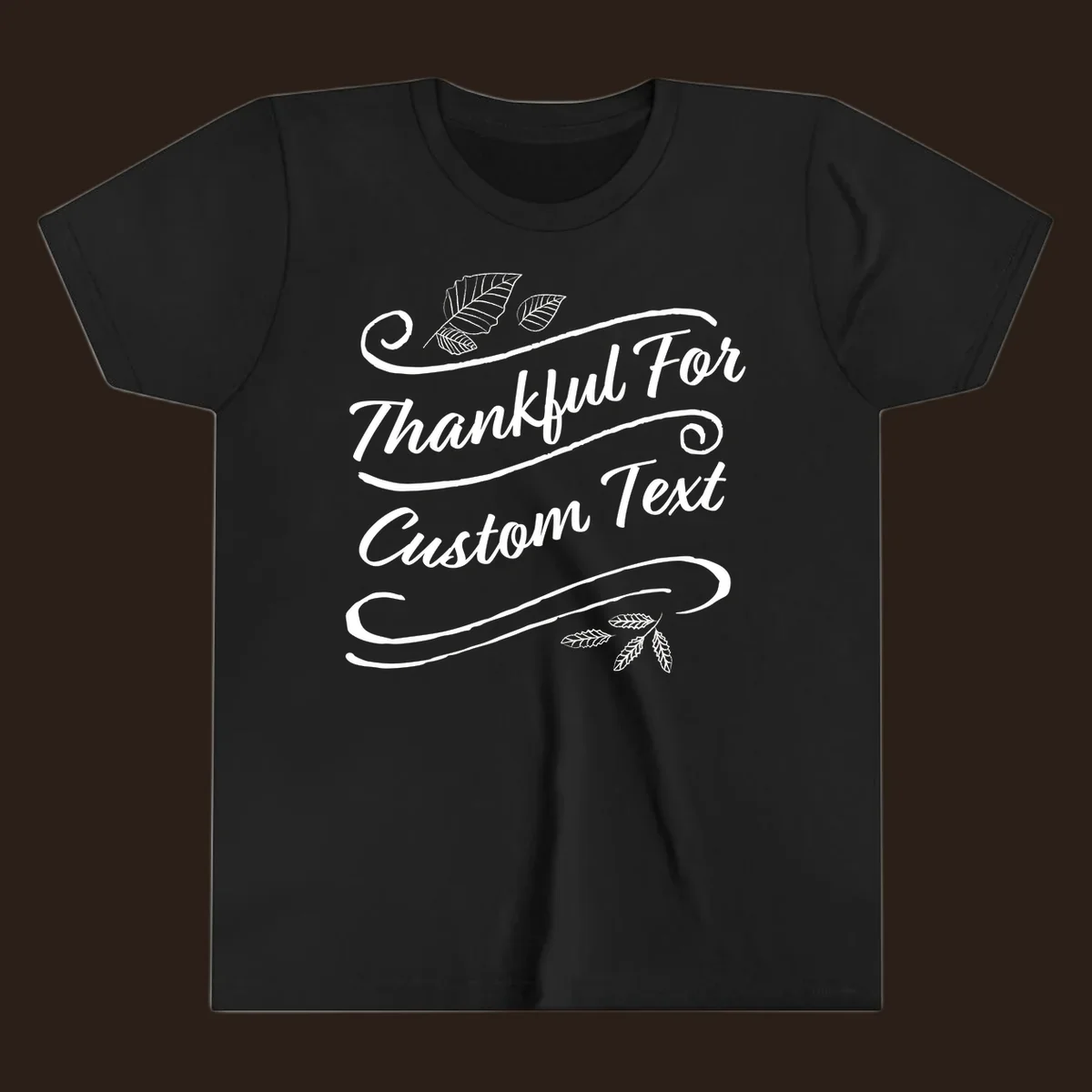 Custom Thanksgiving text design with leaves and swirls.