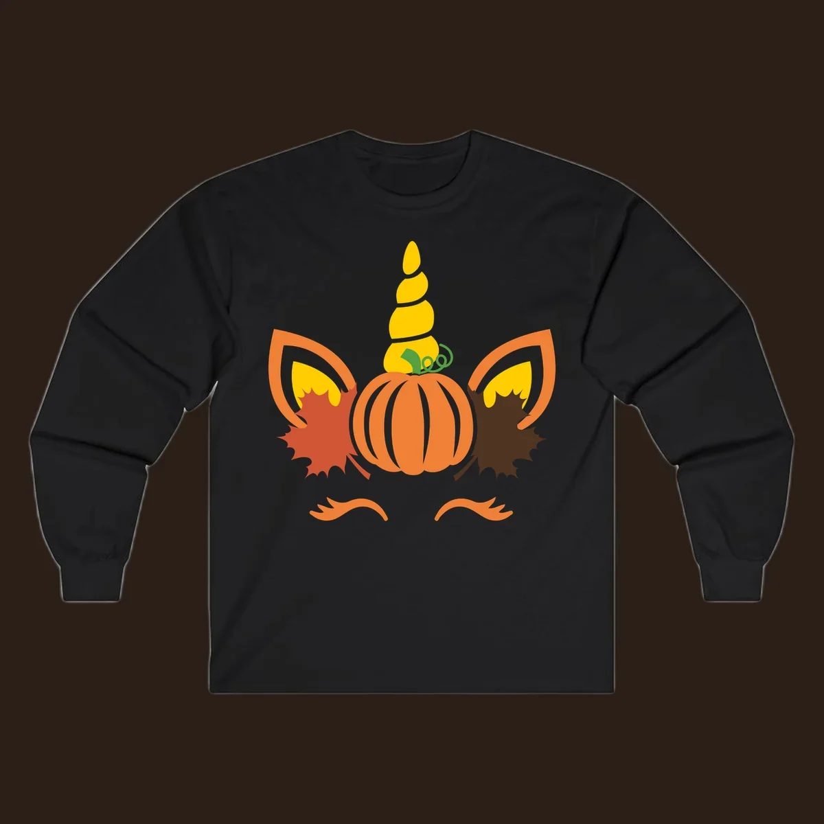 Autumn unicorn pumpkin face with fall leaves graphic.
