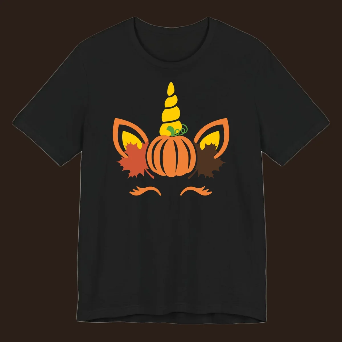 Autumn unicorn pumpkin face with fall leaves graphic.