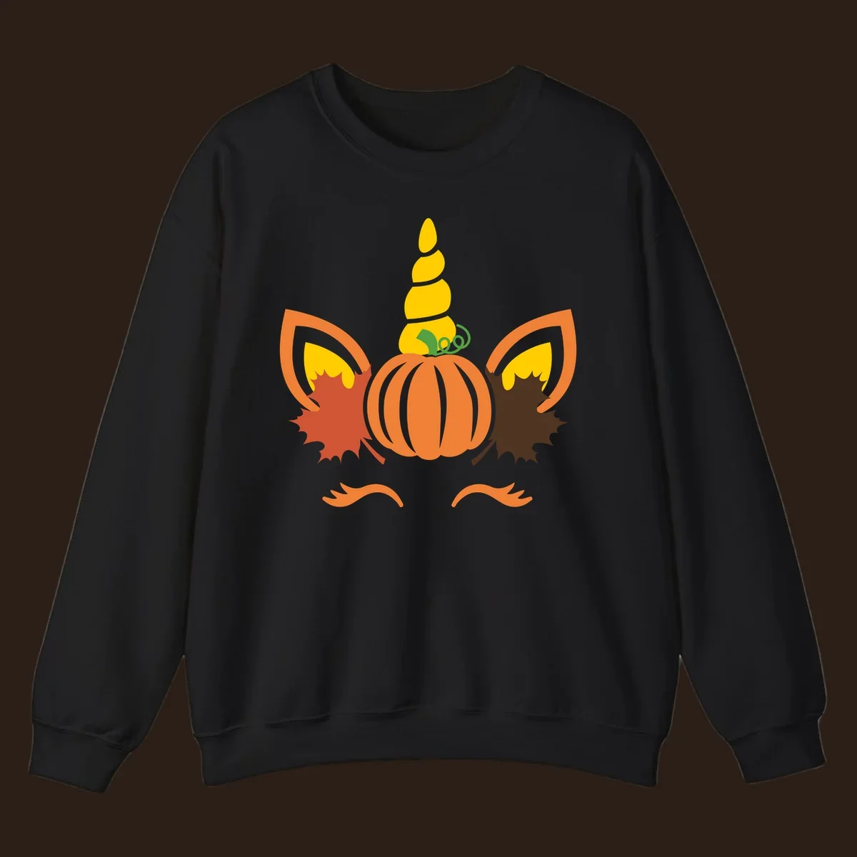 Autumn unicorn pumpkin face with fall leaves graphic.