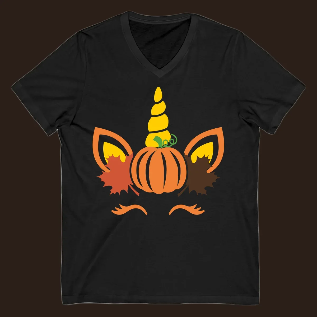 Autumn unicorn pumpkin face with fall leaves graphic.