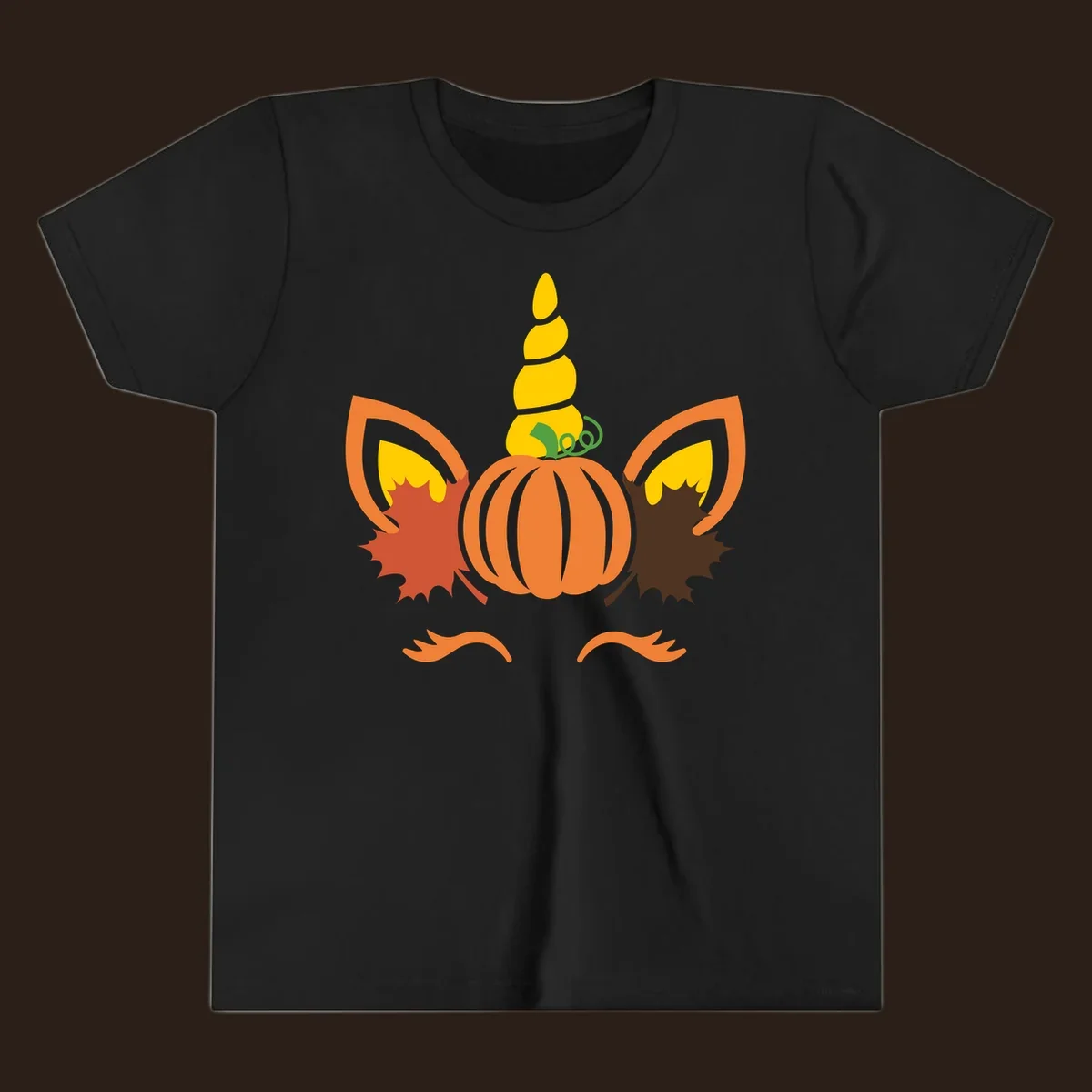 Autumn unicorn pumpkin face with fall leaves graphic.