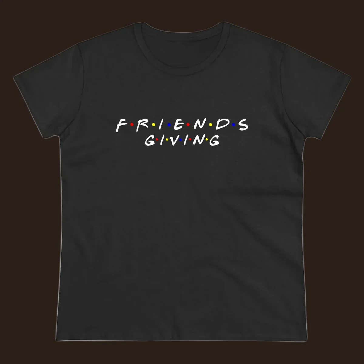 Friendsgiving typography design in white with red, yellow, and blue dots.