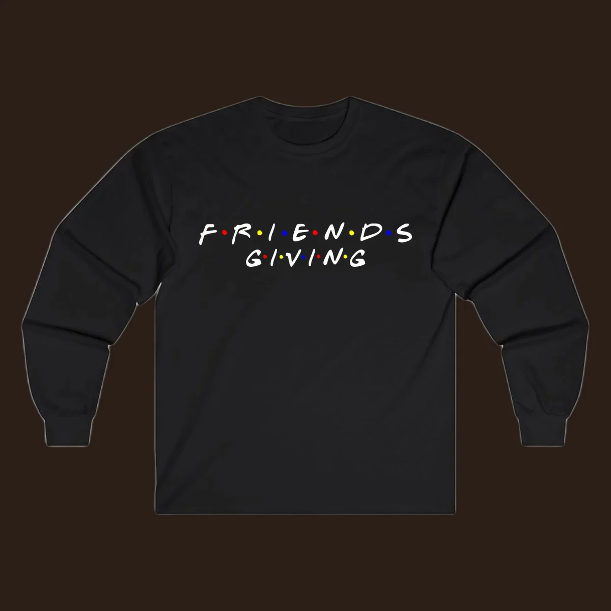 Friendsgiving typography design in white with red, yellow, and blue dots.