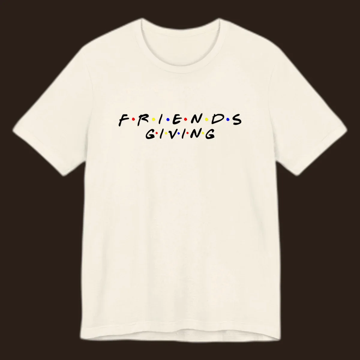 Friendsgiving typography design in white with red, yellow, and blue dots.